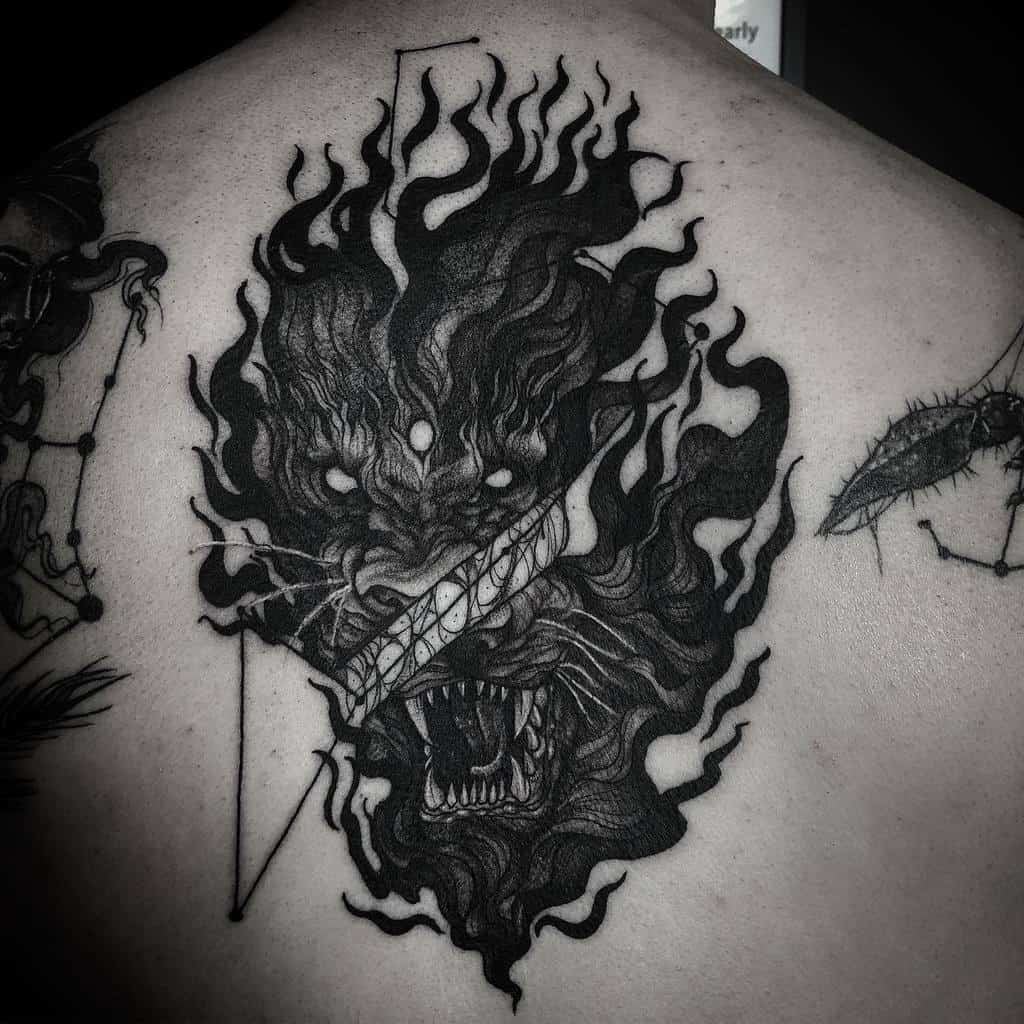 High-detail back tattoo of a roaring lion with a burning aura and celestial elements, representing courage and dominance.