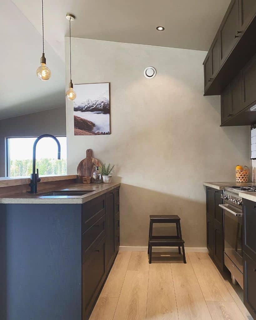 dark galley kitchen brown cabinets small step stool pendant lighting wood flooring