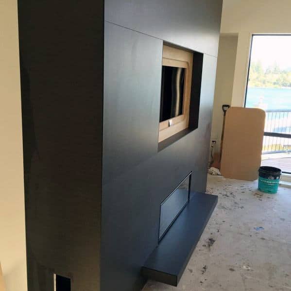 Sleek modern fireplace with dark gray large-format tiles and a minimalist design.