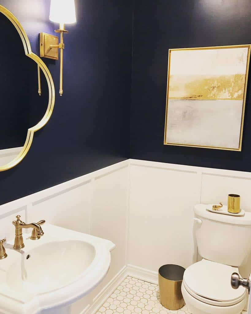 two tone blue and white bathroom wall gold faucets white sink and toilet
