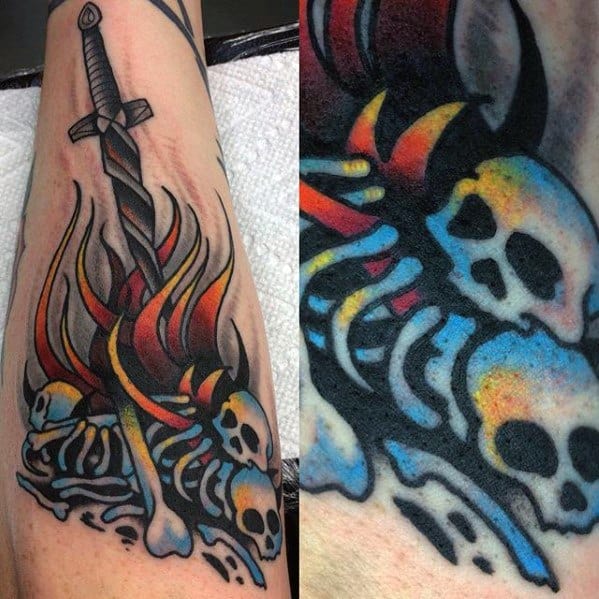 Dark Souls bonfire tattoo with a sword in flames, surrounded by colorful skulls and bones in bold, traditional style.