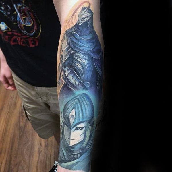 Vibrant Dark Souls forearm tattoo featuring Artorias the Abysswalker and a stylized portrait of a female sorcerer.
