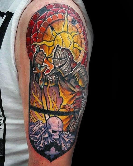 Vibrant Dark Souls tattoo styled like stained glass, featuring a knight by a bonfire, blazing flames, and a skull resting on bones.