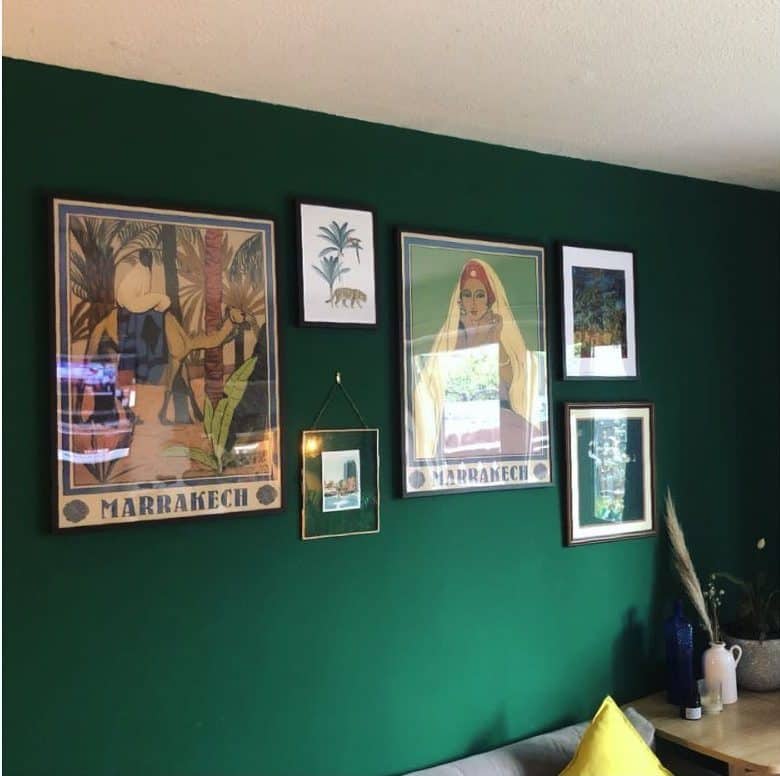green accent wall with framed artwork 
