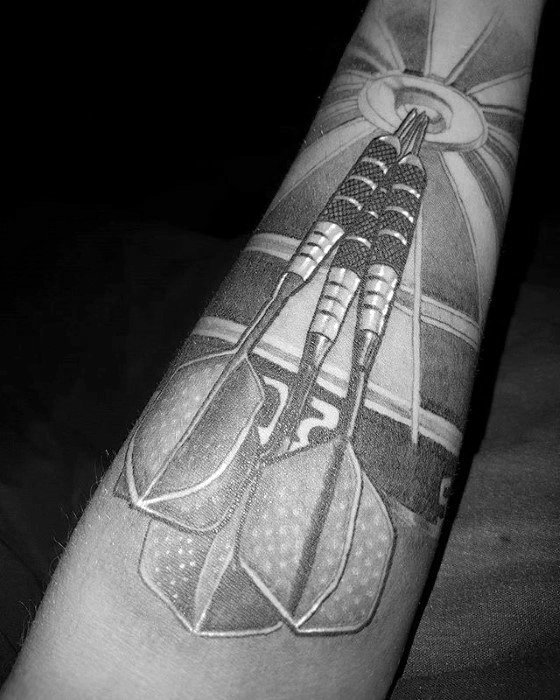 Detailed black and grey tattoo of three darts hitting the bullseye on a dartboard, symbolizing precision, focus, and dedication to the sport.