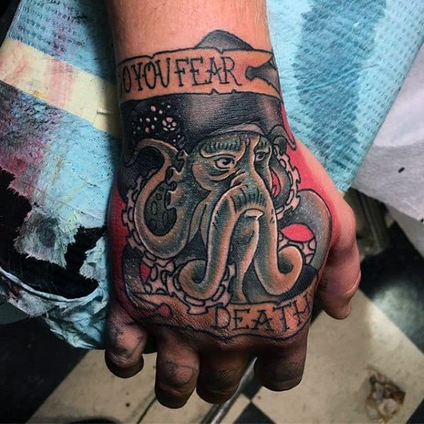 Hand tattoo of Davy Jones' octopus, hat-topped with "Do you fear death" text