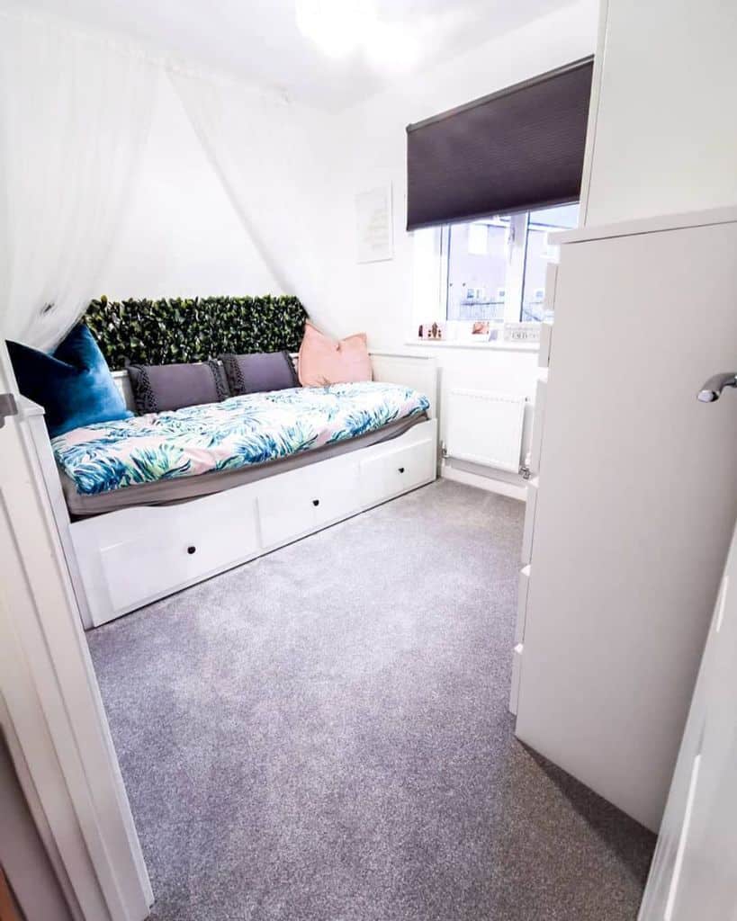 daybed with canopy and drawers in small bedroom