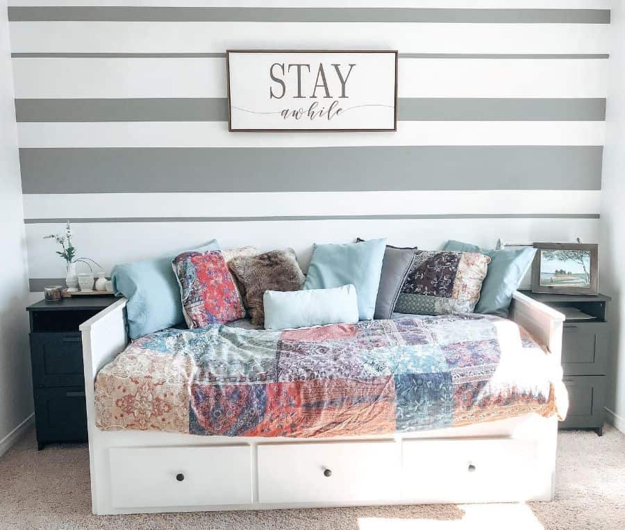 modern living space white daybed with draw storage stay a while artwork
