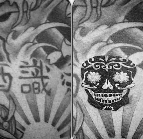Blast over black and white tattoo with Japanese kanji and decorative skull