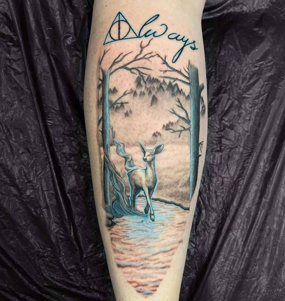 Harry Potter-inspired tattoo featuring the Deathly Hallows symbol, the word 'always' in cursive, and a vivid forest scene with a glowing doe, symbolizing love, loyalty, and the magical Patronus charm