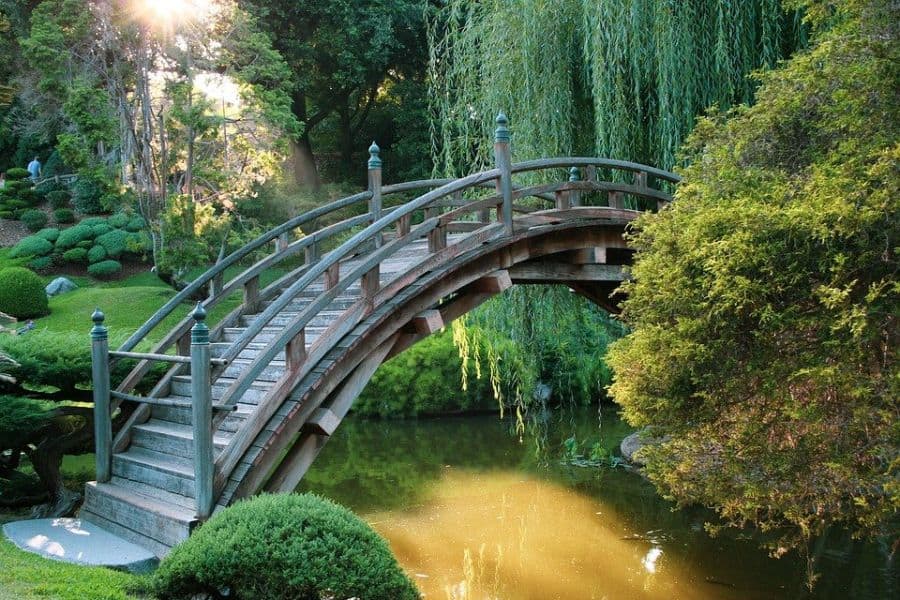 curved shaped wood bridge garden 