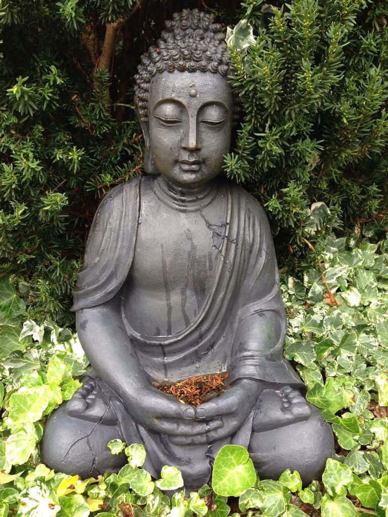asian statue in green garden 