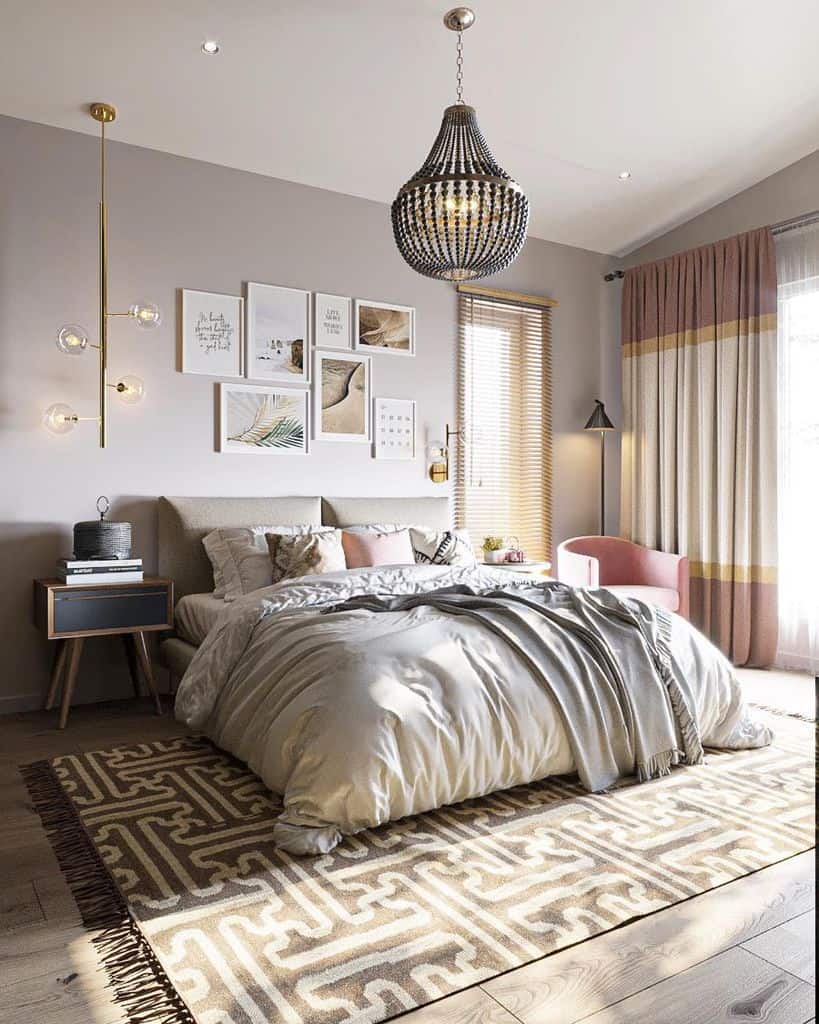 Modern bedroom with framed wall art, elegant chandelier, and patterned floor rug.