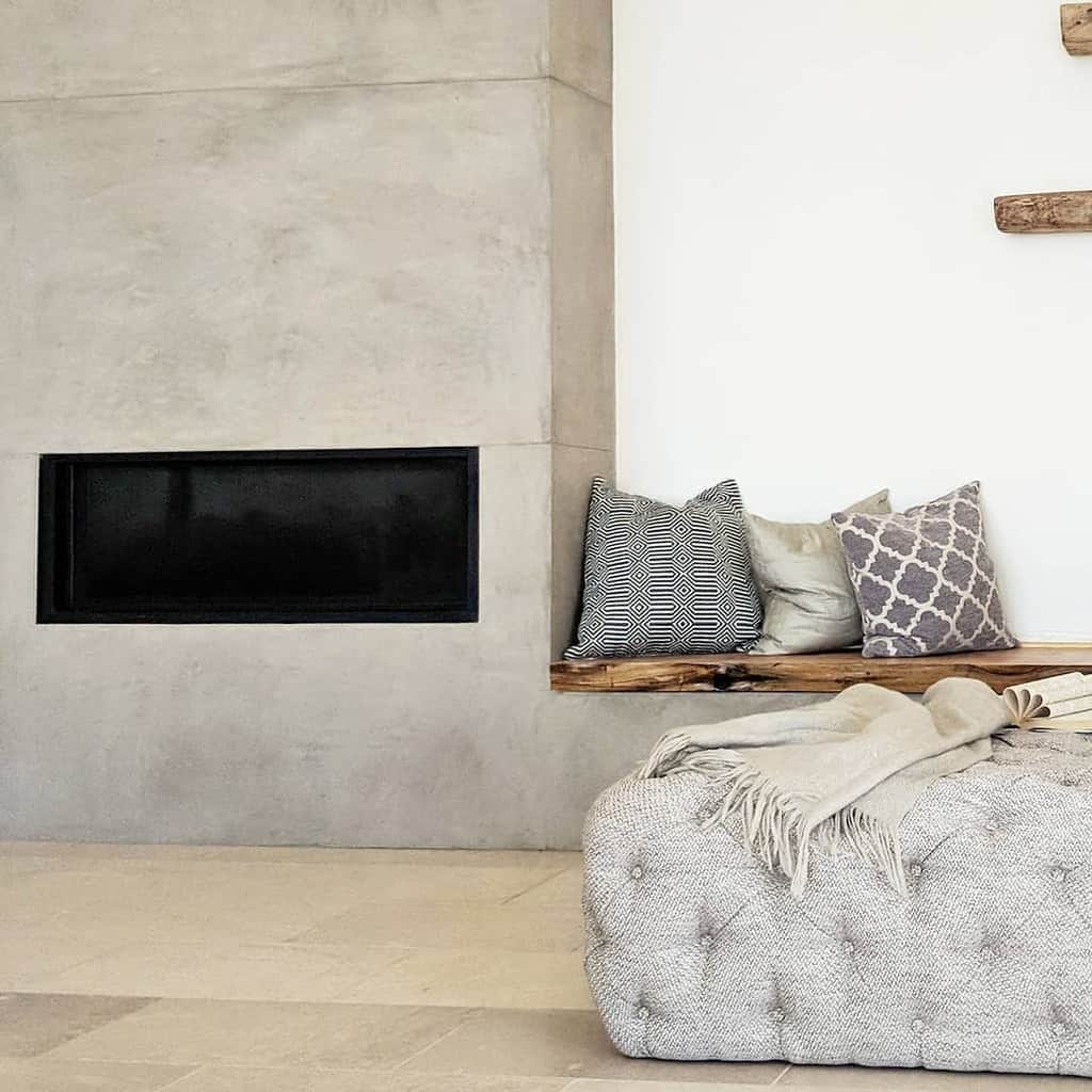 minimalist cement electric fireplace recessed wood bench seating