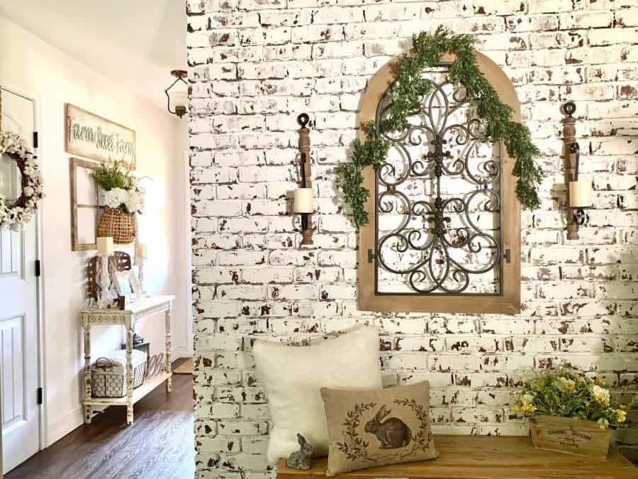 white brick wallpaper wall candles wood bench seating pillows 