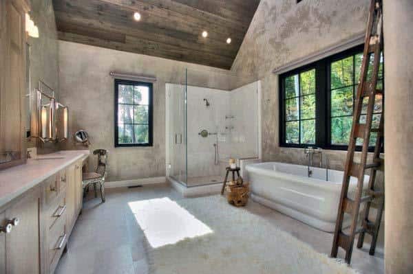 Rustic yet modern bathroom with a glass shower, bathtub, and wooden ladder by large windows