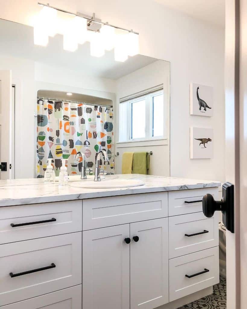 simple kids bathroom white vanity marble countertop dinosaur wall prints colorful shower curtain