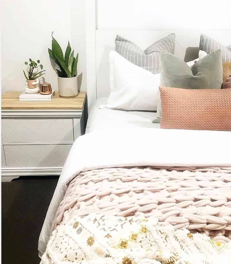 simple platform bed white bedside table small plants