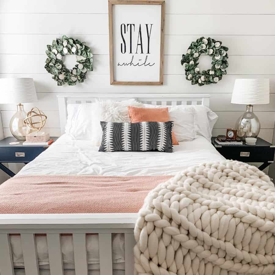 white shiplap wall guest bedroom white wood bed frame glass bulb lamps