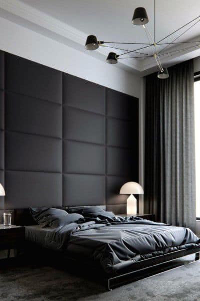Contemporary black bedroom with upholstered accent wall sputnik chandelier and dome lamps.