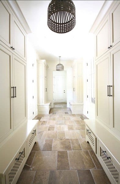 tile floor mudroom with white cabinets