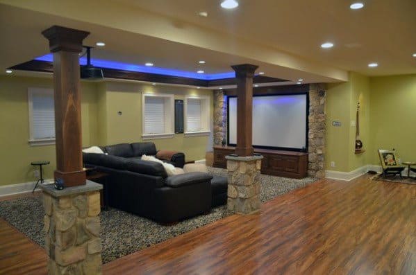 Stone and wood poles with recessed lighting, textured carpet, and wood flooring.