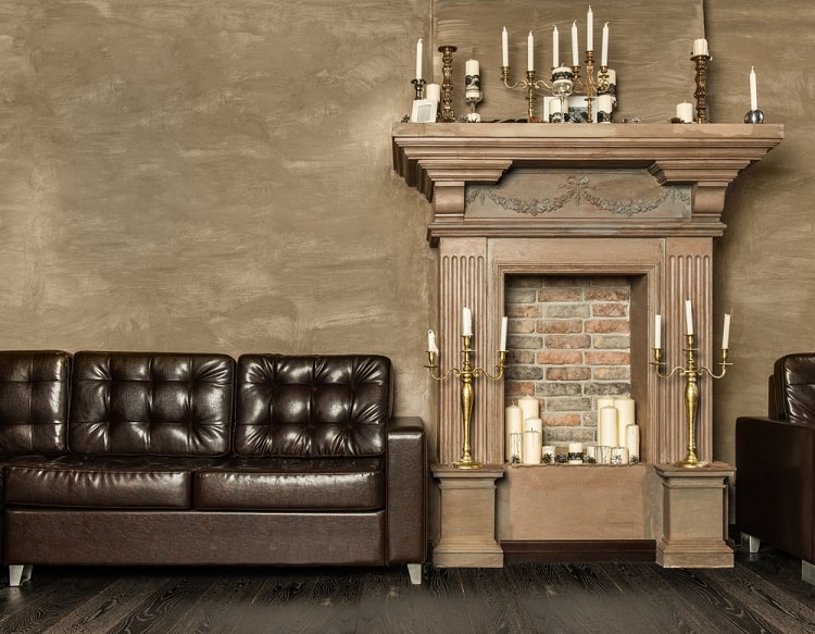 elegant brown wood fireplace and brown leather sofa