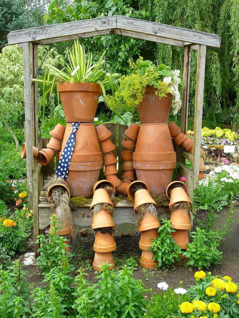 terracotta pots resembling humans in backyard