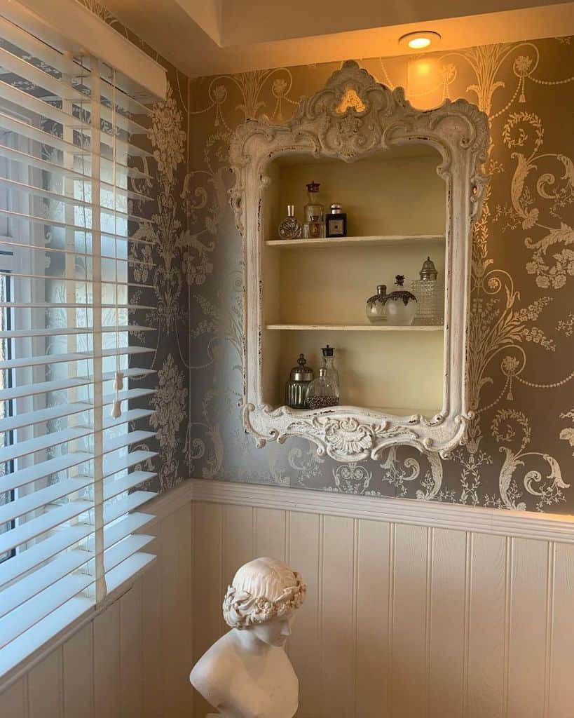 Elegant bathroom shelving with floral wallpaper and decorative bust statue.