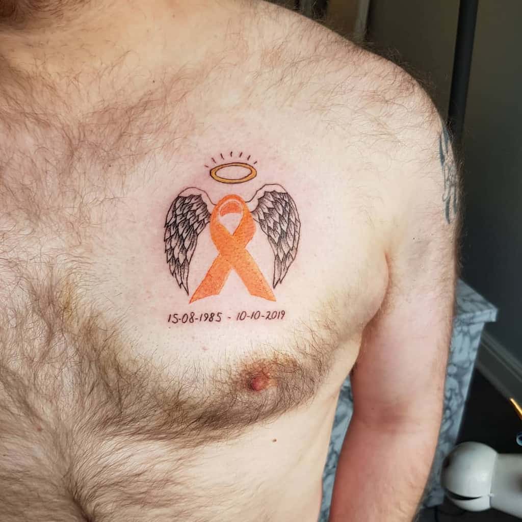A tattoo with angel wings, an orange ribbon, and a halo; dates below: 15-08-1985 - 10-10-2019