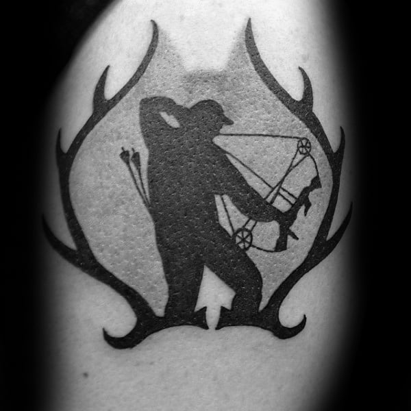 Black silhouette tattoo of a bowhunter aiming a compound bow, framed by stylized deer antlers for a bold and clean design.