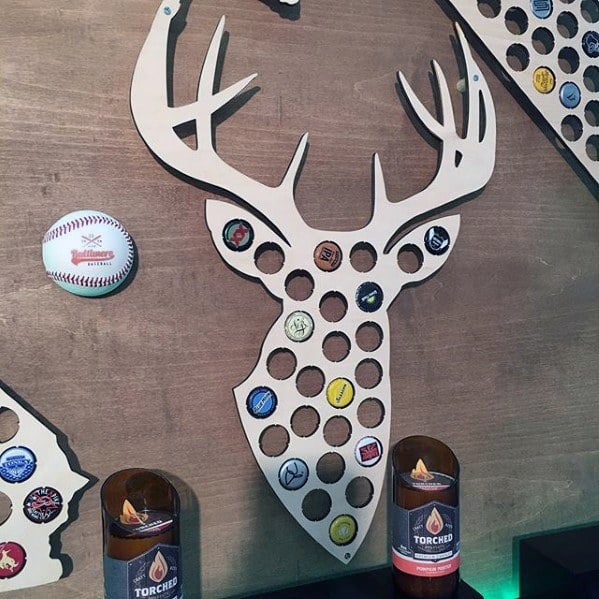 Wooden deer head bottle cap display with various caps, baseball nearby, and Torched products below