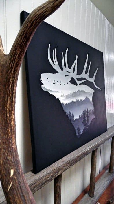 Deer silhouette canvas with a forest landscape design on a dark background.