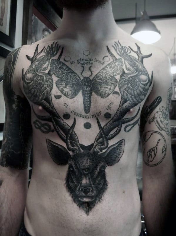 Man with detailed chest tattoo of a deer, moth, and intricate designs