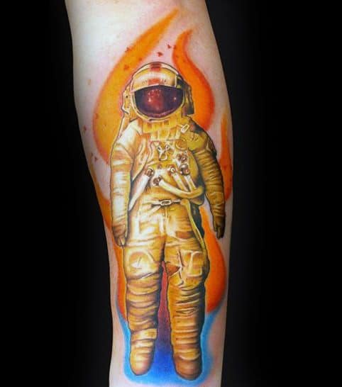 Bright Deja Entendu astronaut tattoo with vivid orange flames and blue glow, giving a fiery and energetic outer space vibe.