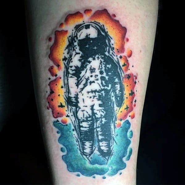 Black and white Deja Entendu astronaut tattoo with splattered rainbow watercolor background for a bold contrast effect.
