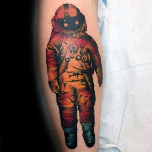 Vibrant Deja Entendu astronaut tattoo with glowing eyes and fiery red, orange, and teal tones creating a surreal effect.