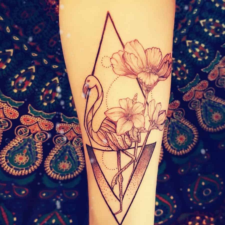 Forearm tattoo featuring a flamingo, blooming flowers, and geometric elements, blending nature with modern line art for an elegant design.