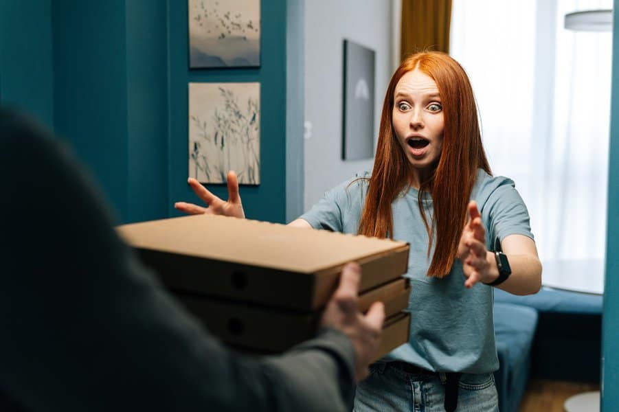 delivery man delivering boxes with food to female client