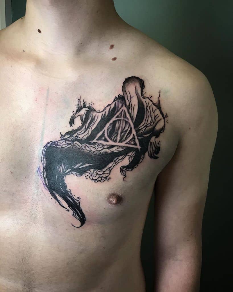 Dark-themed chest tattoo featuring a hooded Dementor-like figure with flowing shadows, incorporating the Deathly Hallows symbol in black ink.