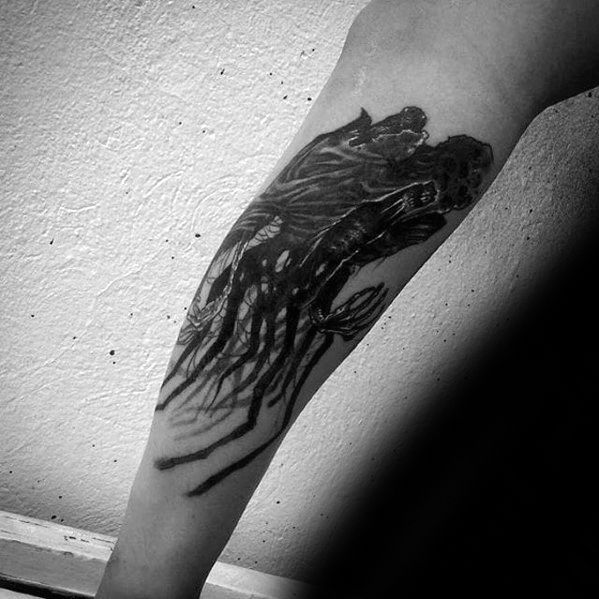 Forearm tattoo of a haunting Dementor with outstretched arms and shadowy tendrils trailing down the arm.