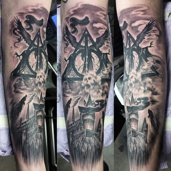 Dark-themed Harry Potter sleeve tattoo featuring the Deathly Hallows, Dementors, a skull, and Hogwarts castle in a stormy sky.