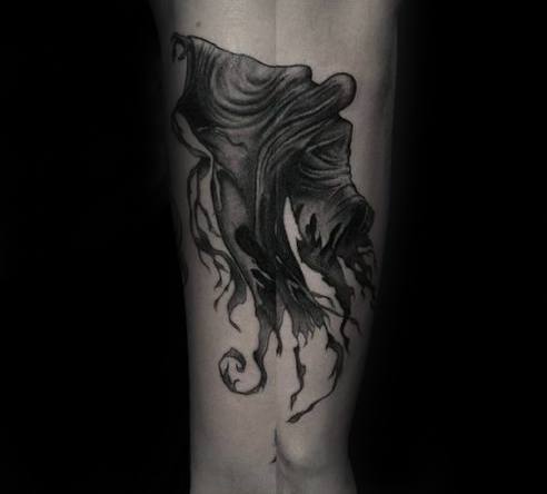 Black and grey Dementor tattoo on the calf, with swirling cloak details and eerie, wispy shadows trailing downward.