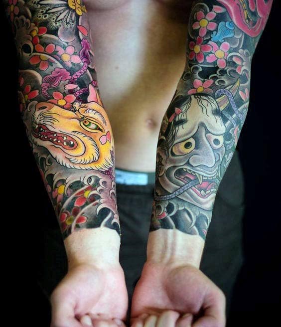 Colorful Japanese-style forearm sleeves featuring a fierce tiger, a dramatic Hannya mask, swirling clouds, and vibrant cherry blossoms