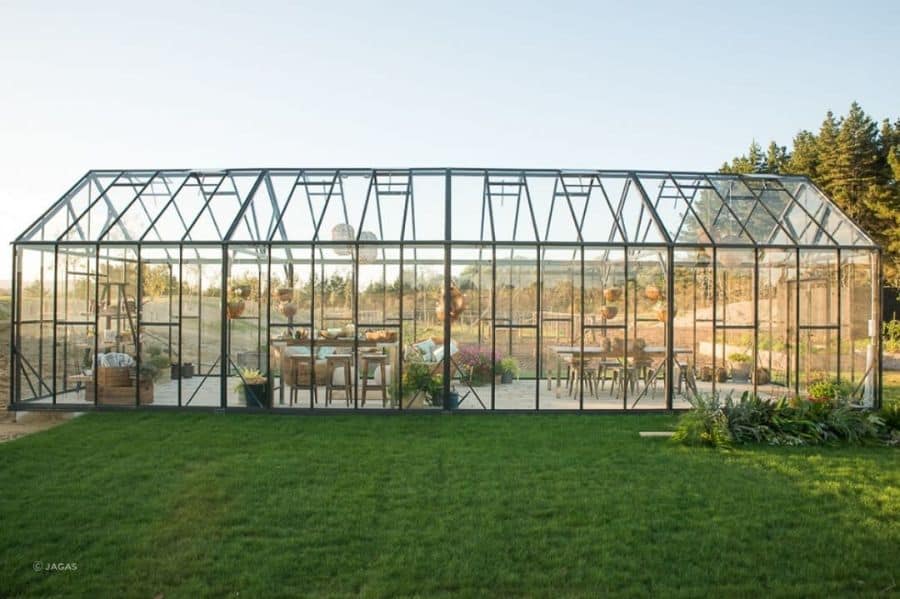 large clear greenhouse hanging plants tables and chairs