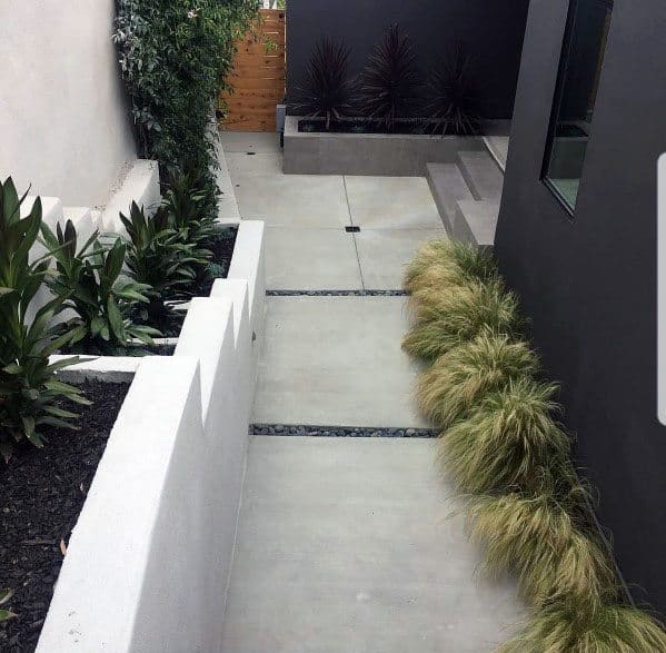 concrete steps with landscaping pebbles 