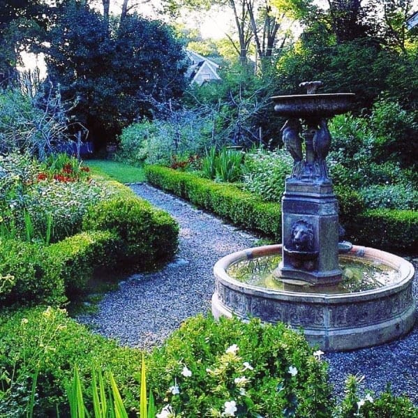 hedge-lined walkway with rotunda centerpiece sculpture fountain