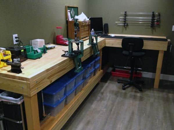 Spacious reloading bench with multiple presses, storage bins, and a comfortable workspace for efficient reloading