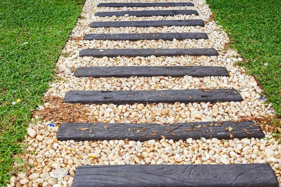 Walkway with dark wooden steps surrounded by grass