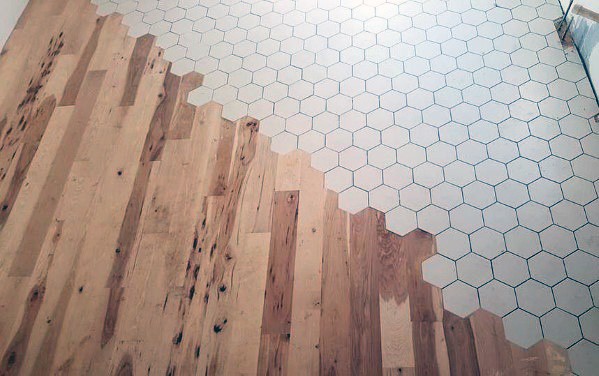 Hexagonal tile-to-wood floor transition blending white tiles with natural wood planks for a smooth and stylish modern finish